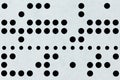 Background macro of perforated punched tape Royalty Free Stock Photo