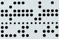 Background macro of perforated punched tape Royalty Free Stock Photo