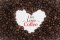 Background made of coffee beans in a heart shape with message `Live Love Coffee`