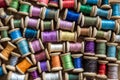 The background is made of colorful threads on wooden vintage reels. Skeins of colored thread. Top view