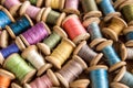 The background is made of colorful threads on wooden vintage reels. Skeins of colored thread. Top view