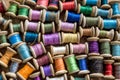 The background is made of colorful threads on wooden vintage reels. Skeins of colored thread. Top view