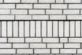 Background made of the facade of the building made white brick, a large fugue between the bricks is visible. Royalty Free Stock Photo