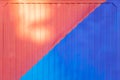 Background made of metal profile painted in blue and red on the fence or container backlit Royalty Free Stock Photo