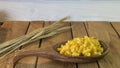 Background made of oak planks and pine planks painted white on the table a bunch of grain wood a wooden spoon with noodles