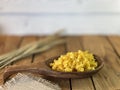 Background made of oak planks and pine planks painted white on the table a bunch of grain wood a wooden spoon with noodles