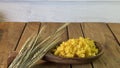 Background made of oak planks and pine planks painted white on the table a bunch of grain wood a wooden spoon with noodles