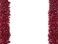 Background made of red pomegranate seeds. The scattered red grains of a pomegranate. Garnet at border of image with copy space for