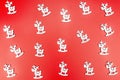 Background made of silver reindeer arranged randomly on a red background. Royalty Free Stock Photo