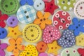 The background is made up of multicolored buttons of different sizes and shapes. Royalty Free Stock Photo