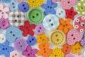 The background is made up of multicolored buttons of different sizes and shapes. Royalty Free Stock Photo