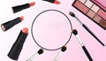 background makeup, lipstick, brush for powder and powder, circle in the middle as copy space, pink-white background Royalty Free Stock Photo