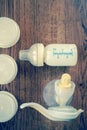 Background of manual breast pump and baby bottle with milk