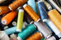 Background of many colorful spools of thread closeup. Sewing hobby concept. Pile of threads bobbins Royalty Free Stock Photo