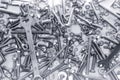 Background of many different metal rivets, wrenchs, screws and bolts of silver and black color Royalty Free Stock Photo