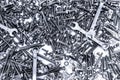 Background of many different metal rivets, wrenchs, screws and bolts of silver and black color Royalty Free Stock Photo