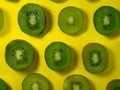 Background of many kiwi slices. Sliced kiwi on a yellow background. Raw food concept. Sliced fruits Royalty Free Stock Photo