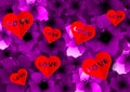 Background with many paper volume hearts red with love text inserted into a cutout. Carpet of purple flowers, pink floral pattern