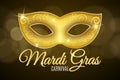 Background for Mardi Gras carnival. Gold glitter text. Luxurious gold glitter mask with sparkles for a masquerade. Golden shine. L Royalty Free Stock Photo