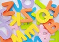 Messy heap of sponge rubber alphabet letters background.