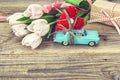 Background with miniature blue toy car carrying a heart and pink Royalty Free Stock Photo