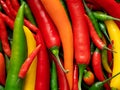 Background of mixed red, yellow, orange and green cayenne chillies from above Royalty Free Stock Photo