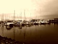 Background of moored yatchs in evening light with reflections on water