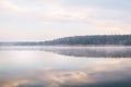 Background. Mountain lake in the fog. Magic morning. Fog spreads beautifully over the water surface. The trees are almost Royalty Free Stock Photo