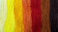 Background from multi-colored threads. Rainbow thread in red tones. Royalty Free Stock Photo