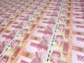 A background of neat rows of 100000 Indonesian Rupiah. Paper money, currency or banknotes of Indonesia Royalty Free Stock Photo