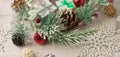 Christmas light gray background on whitewashed wooden boards with green spruce wreath, toys, silver snowflakes and gifts Royalty Free Stock Photo