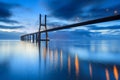 Background with night lights on the Lisbon bridge. The Vasco da Gama Bridge is a landmark, and one of the longest bridges in the w Royalty Free Stock Photo