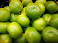Background. Not ripe green tangerines with yellow barrels. Close-up