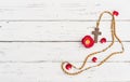 Rosary cross and beads with rose on white wood, religious background