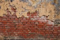 Background of old brick wall with peeling plaster Royalty Free Stock Photo