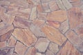 Background of old brown tiles made of irregular shaped stones
