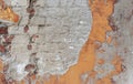 background of old cracked brick wall with sprinkled cement plaster and remnants of paint Royalty Free Stock Photo