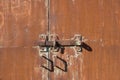 Texture of a rusty gate with a hinged and padlock lock. Gates with door handles Royalty Free Stock Photo