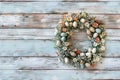 on background of old painted boards an Easter wreath with many decorative elements Royalty Free Stock Photo