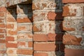background of an old red brick wall. An unusual design made of bricks and cement of an old building. Cobwebs on the surface of an Royalty Free Stock Photo