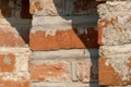 background of an old red brick wall. An unusual design made of bricks and cement of an old building. Cobwebs on the surface of an Royalty Free Stock Photo