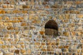 Background of old stone wall with a loophole Royalty Free Stock Photo