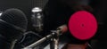 On the background are old vinyl records with a red center, a microphone and an amplifier Royalty Free Stock Photo