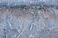 Background of old wooden bridge over a forest stream surface covered with hoarfrost, frost, morning sunlight.