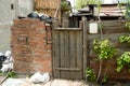 Background old wooden door, brick wall and trash bags