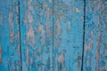 Background from an old wooden door painted in blue. Texture of peeling paint on the boards Royalty Free Stock Photo