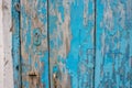 Part of an old wooden door with peeling blue paint and a keyhole Royalty Free Stock Photo