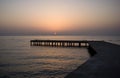 Background with old wooden pier in the sea at sunset Royalty Free Stock Photo