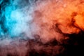 Background of orange, purple, red and blue wavy smoke on a black isolated ground. Abstract pattern of steam from vape of smoothly Royalty Free Stock Photo