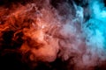 Background of orange, purple, red and blue wavy smoke on a black isolated ground. Abstract pattern of steam from vape of smoothly Royalty Free Stock Photo